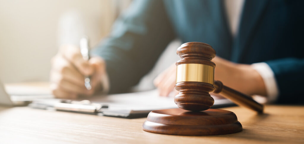 Close-up photo of a Court Judge's Gavel resting on his/her desk.