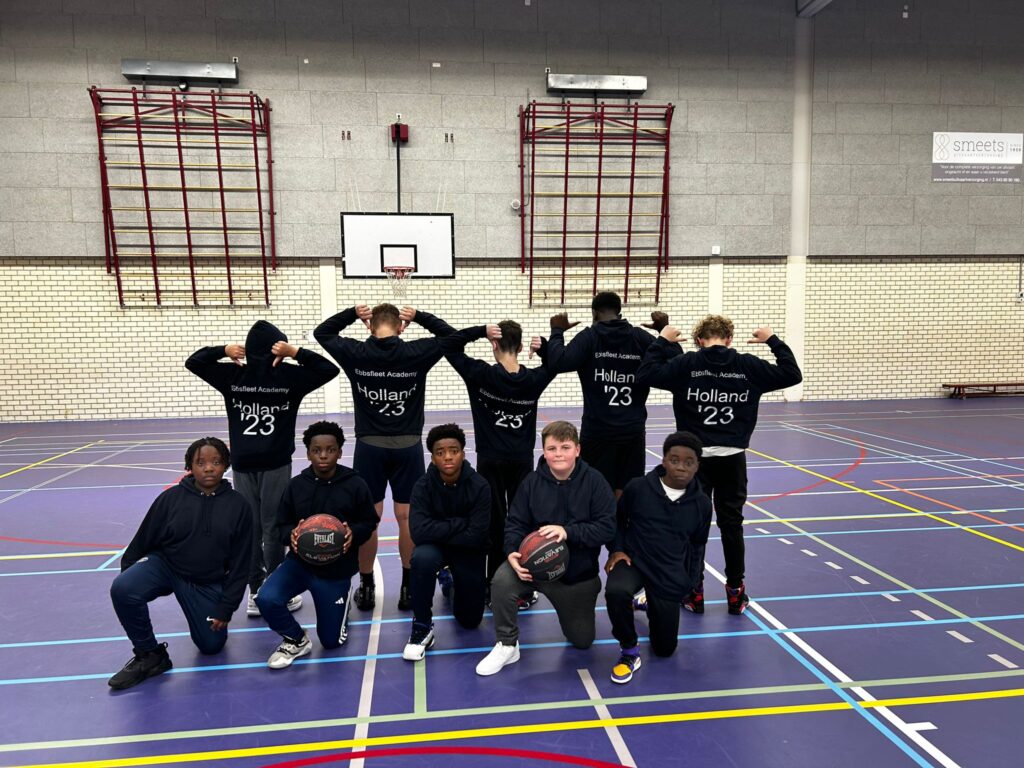 Students on the Holland trip posing wearing their hoodies