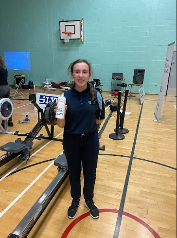 A female Leigh Academy Ebbsfleet student is seen smiling for the camera, whilst at Sir Joseph Williamson's Mathematical School for a Rowing Competition.