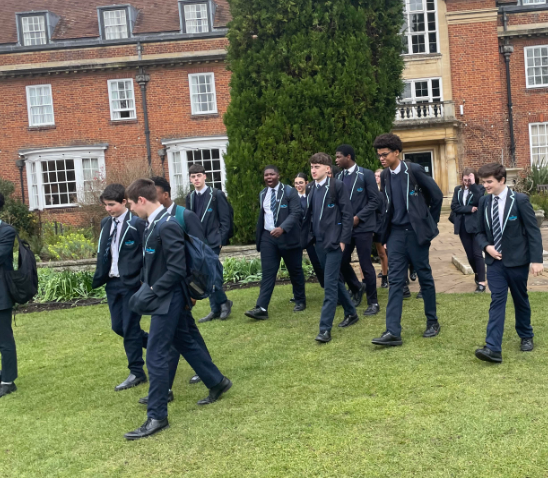 Year 11 and 12 students from Leigh Academy Ebbsfleet are pictured walking across an outdoor space on the grounds at Oxford University during a school trip there.