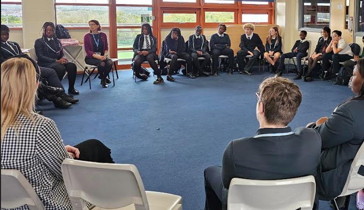 Students sat on chairs in a circle