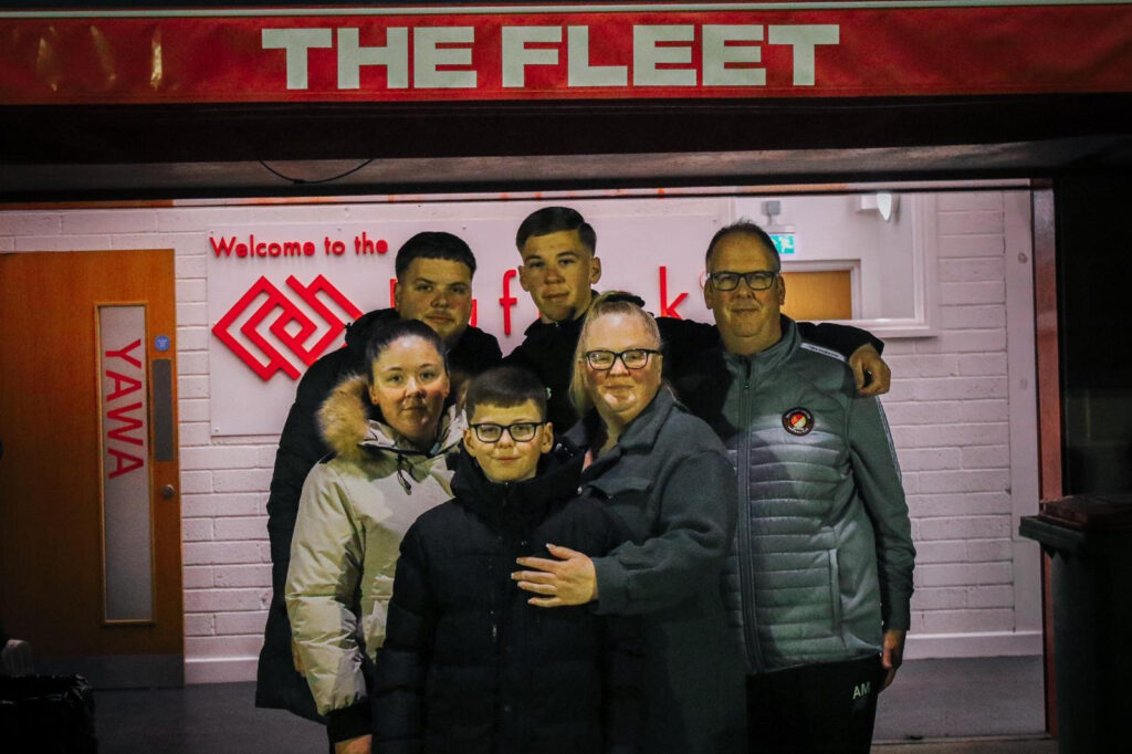 Former student Maxx and his family posing outside Ebbsfleet Football Club