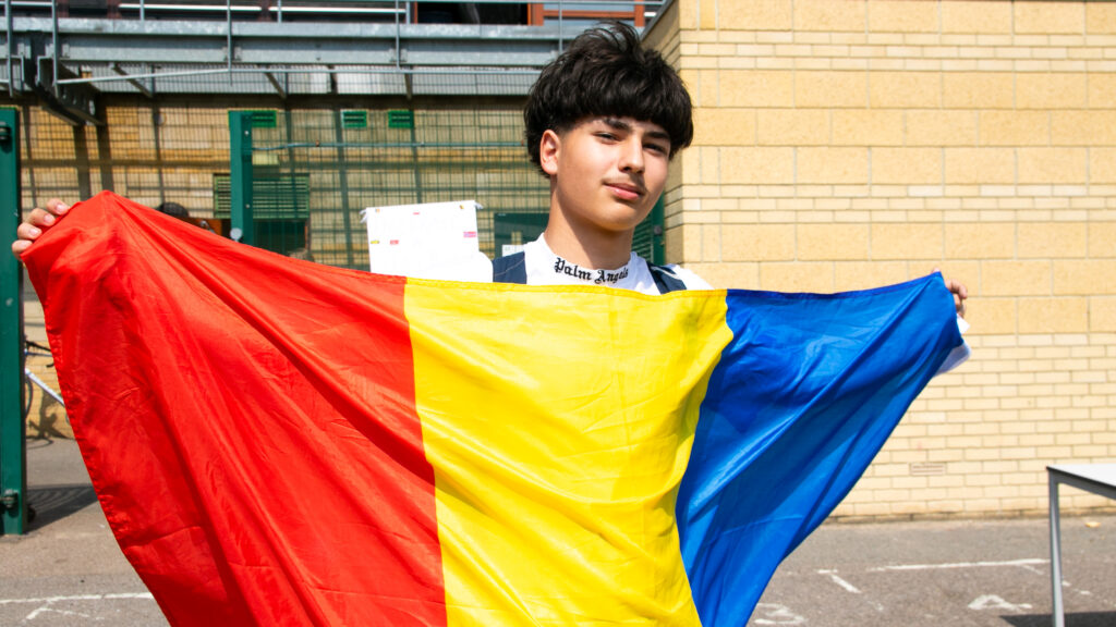 A student waving their flag
