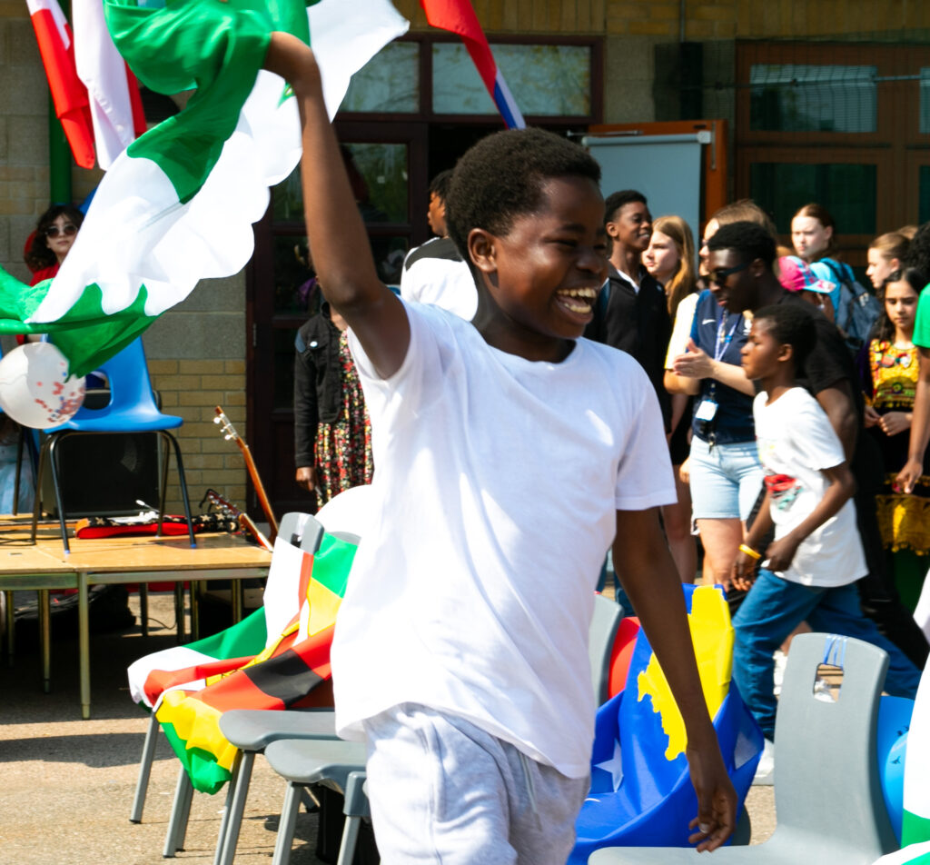 A student waving their flag